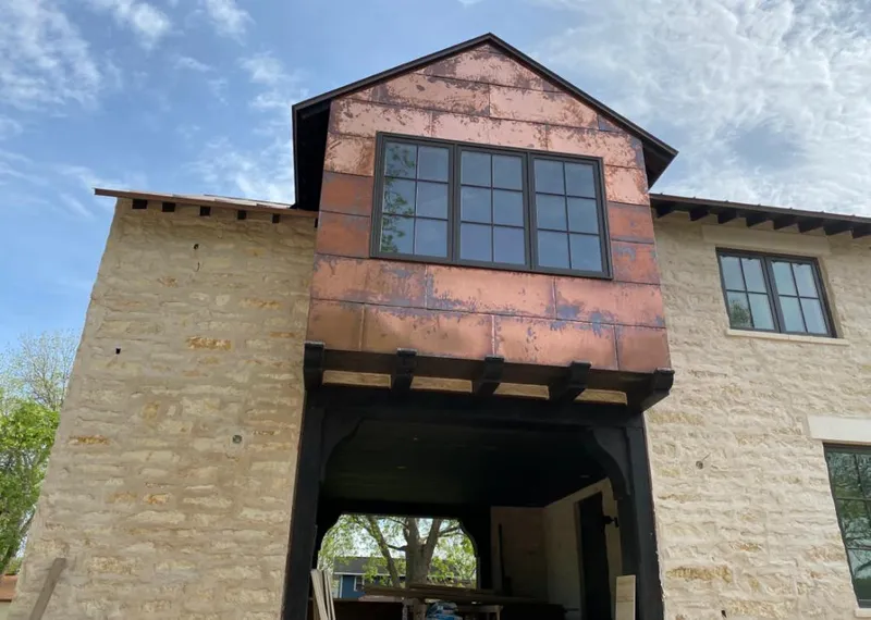 Copper metal panel facade on a stone building for Roof Repair in Perrysburg